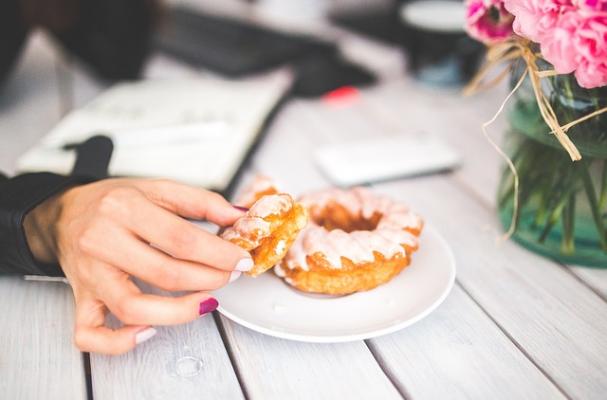 woman's hand holding donut